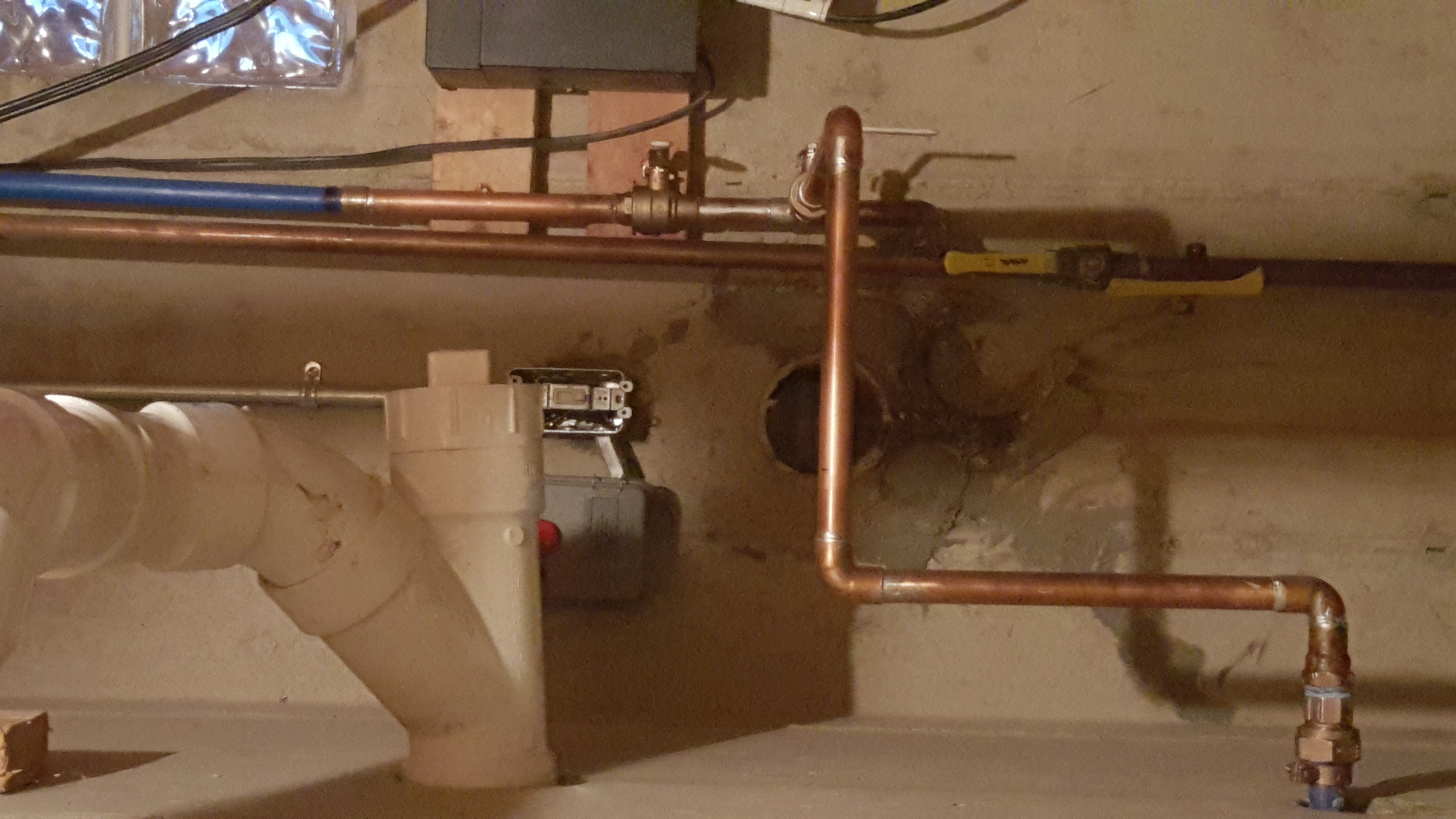 PVC pipes installed in trenches on a construction site, likely for plumbing